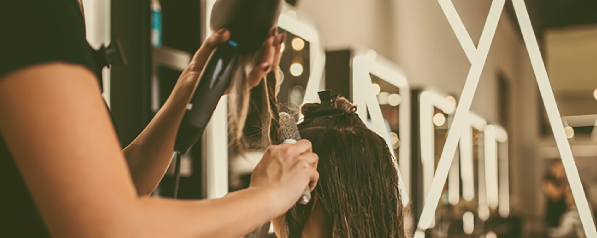 Professional stylist working on client's hair